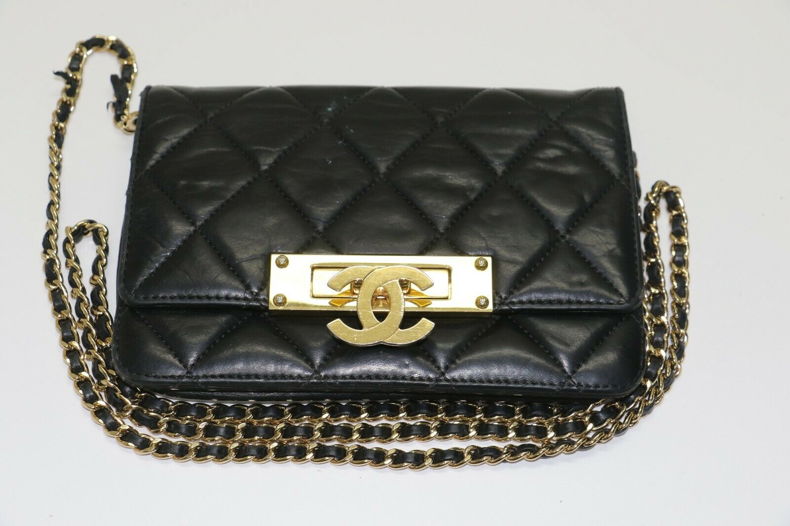 Chanel: Quilted Black Leather Chain Clutch - Flip Lock – GEM Pawnbrokers